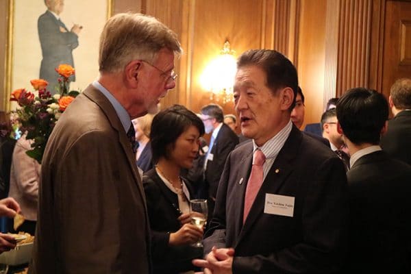 Hon. Yukihisa Fujita, Member, House of Councillors (right) speaks with Henry Nau of George Washington University. 