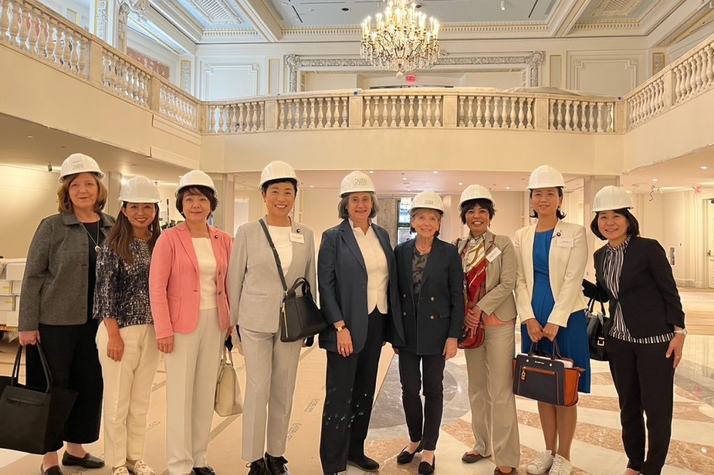 Susan Steerling and Ilene Gutman greet the delegation amid the museum's renovation